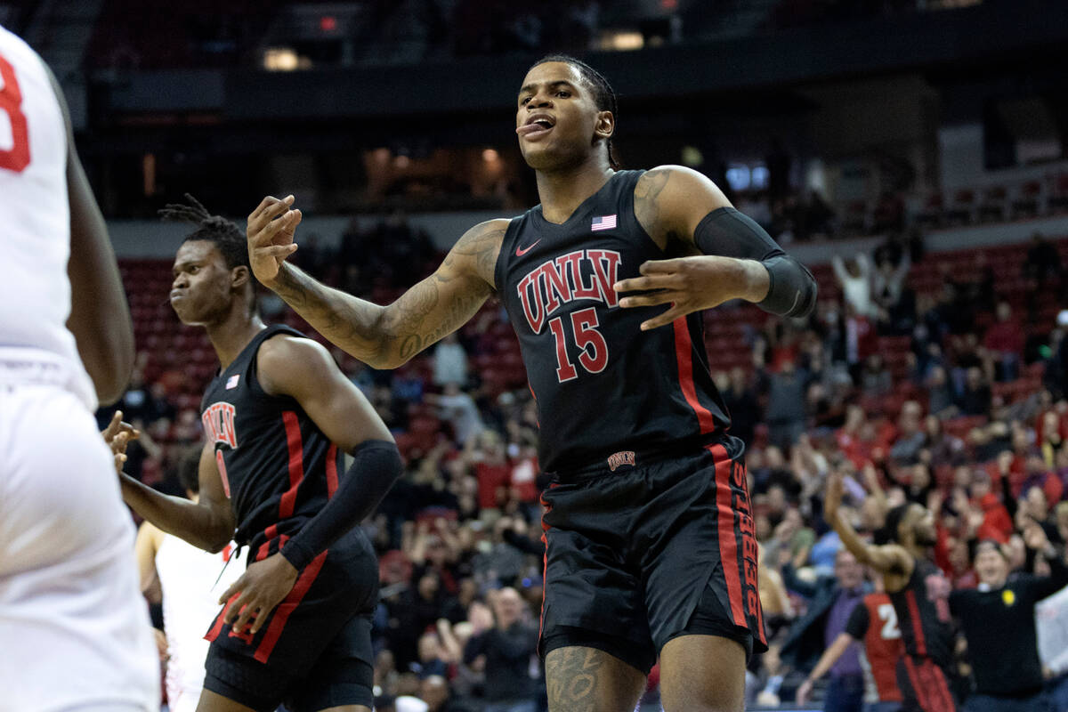 UNLV Rebels guard Luis Rodriguez (15) and forward Victor Iwuakor (0) celebrate after their team ...