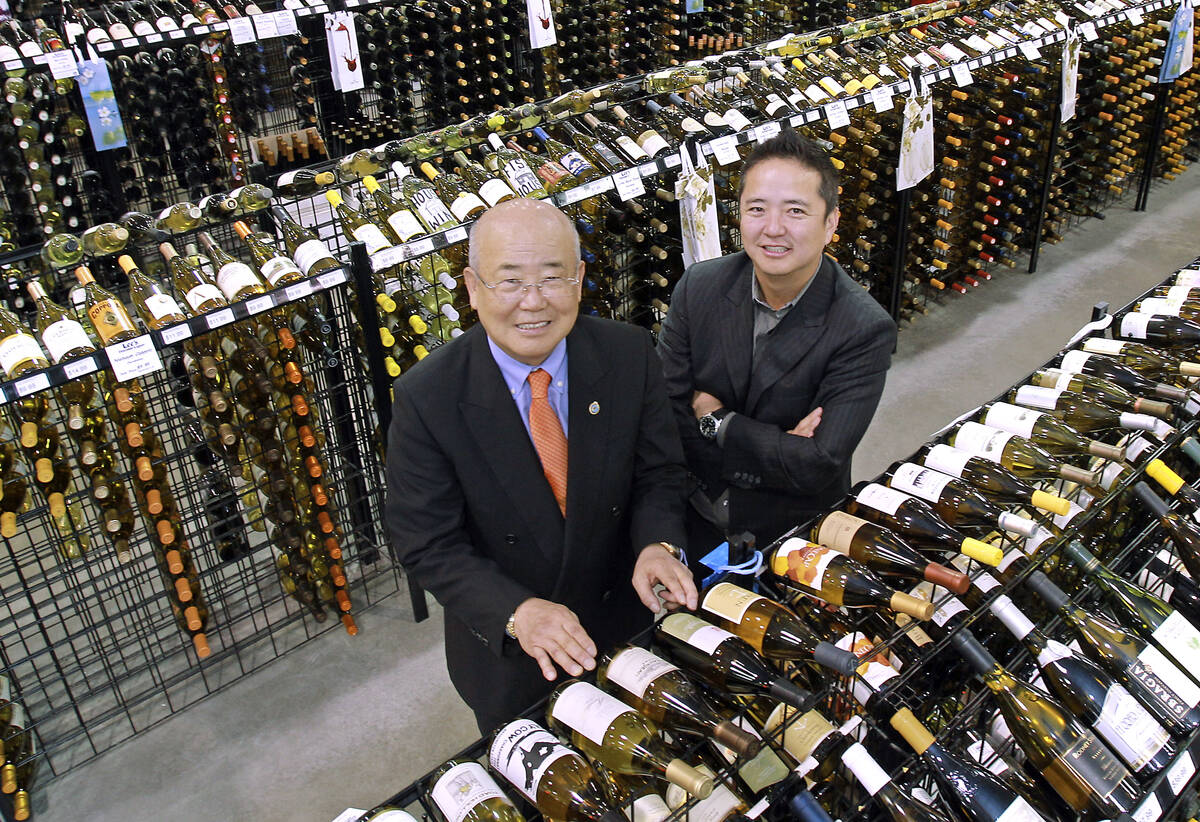 Hae Un Lee, CEO of Lee's Liquor, from left, poses with his son Kenny Lee, President, in their s ...