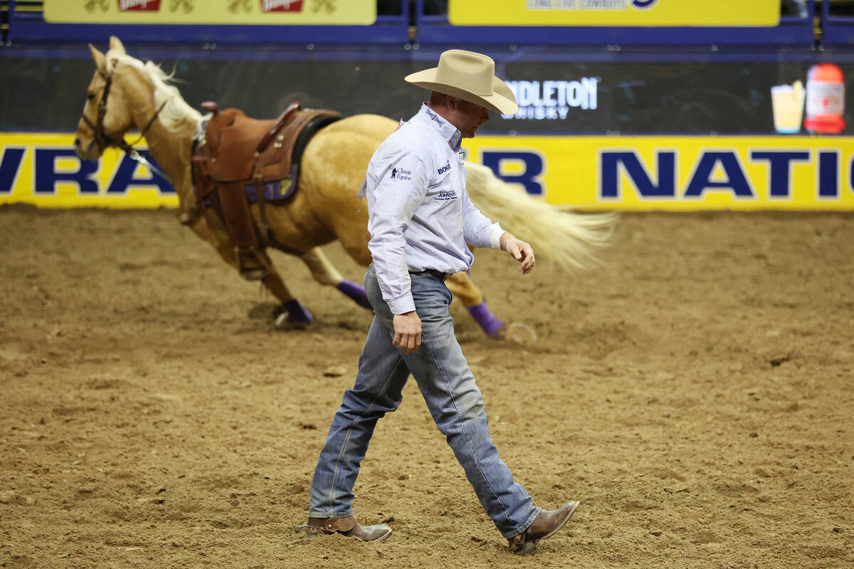 Hunter Cure walks away after his steer wrestling event run in the 64th Wrangler National Finals ...