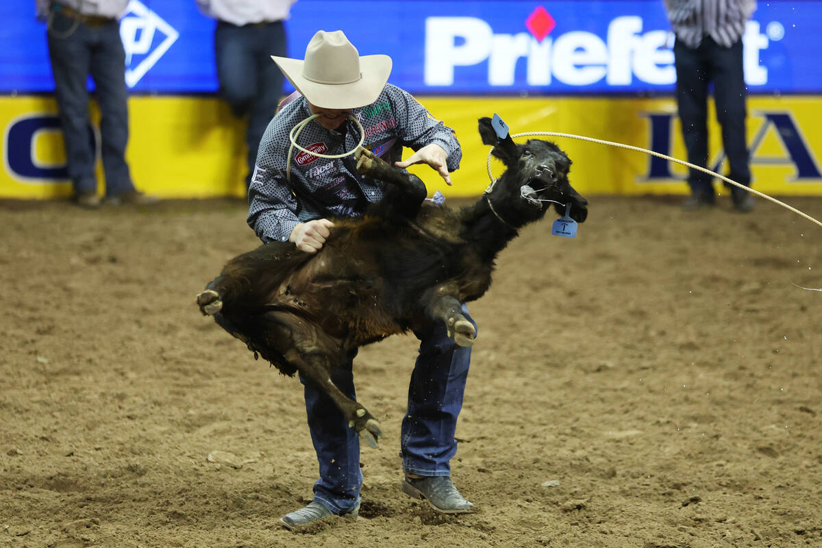 Riley Webb competes in the tie-down roping event during the 64th Wrangler National Finals Rodeo ...