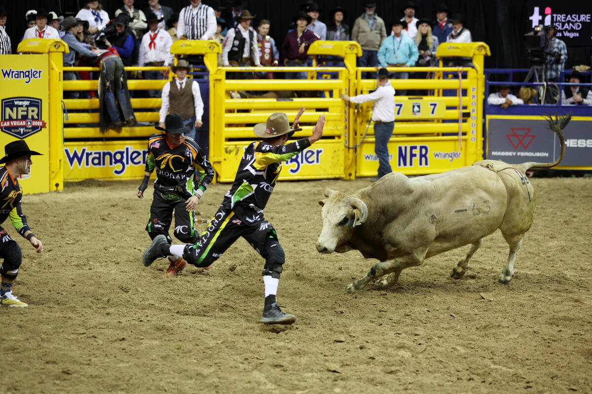 Rodeo clowns work a loose bull during the bull riding event in the 64th Wrangler National Final ...