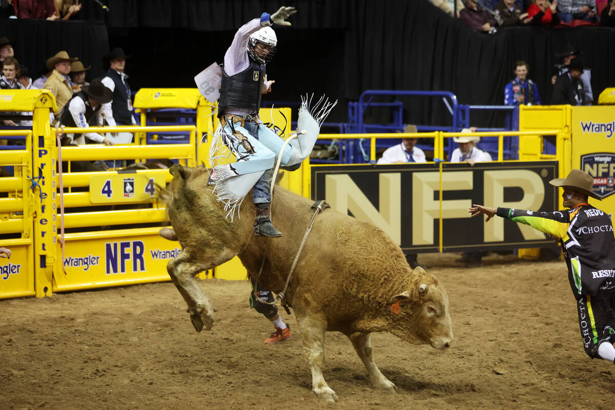 Creek Young competes during the bull riding event in the 64th Wrangler National Finals Rodeo at ...