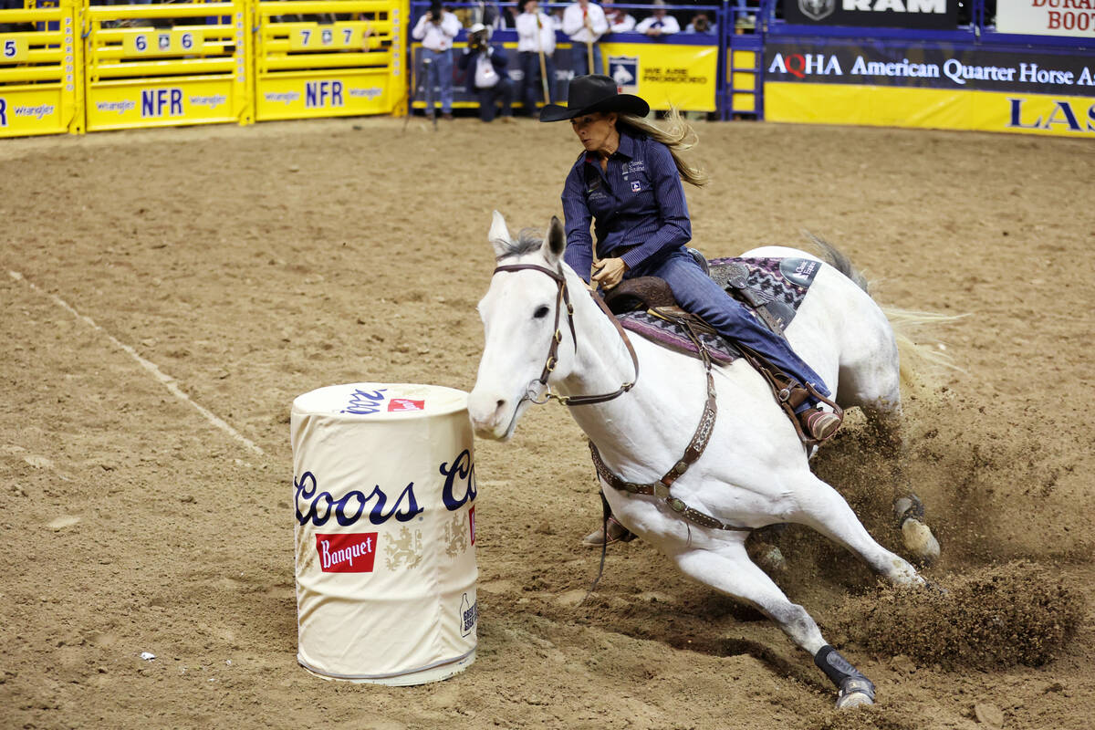 Kassie Mowry competes in the barrel racing event in the 64th Wrangler National Finals Rodeo at ...