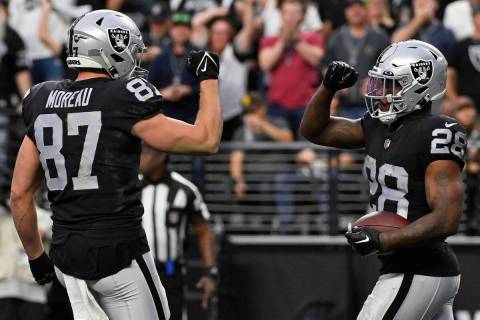 Las Vegas Raiders running back Josh Jacobs (28) celebrates his touchdown with tight end Foster ...