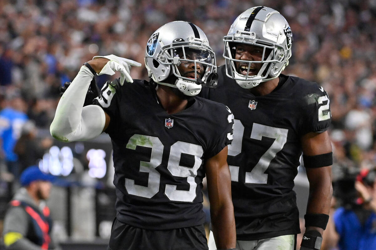 Las Vegas Raiders cornerback Nate Hobbs (39) celebrates with cornerback Sam Webb (27) after the ...