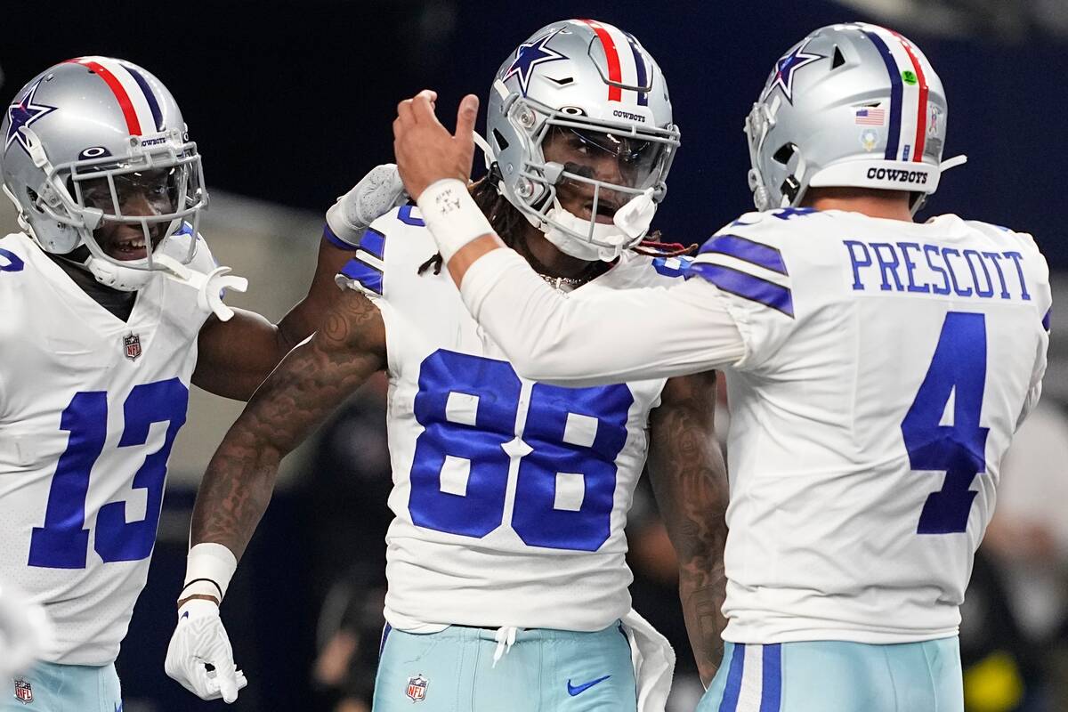 dDallas Cowboys quarterback Dak Prescott (4) celebrates a touchdown catch with CeeDee Lamb (88) ...