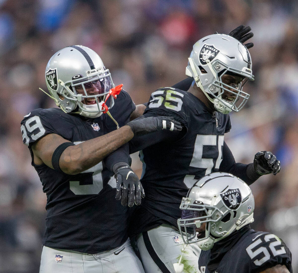 Raiders defensive end Clelin Ferrell (99) congratulates defensive end Chandler Jones (55) on hi ...