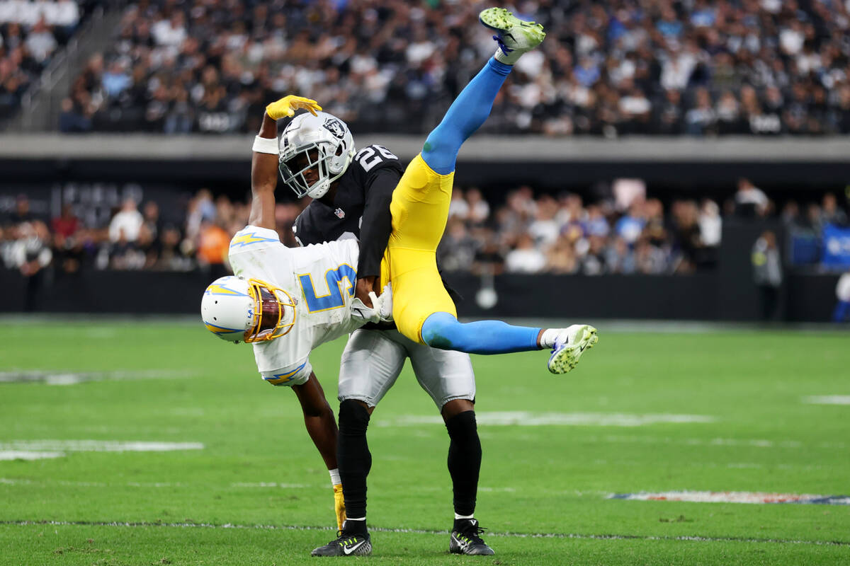 Raiders linebacker Curtis Bolton (36) tackles Los Angeles Chargers wide receiver Joshua Palmer ...