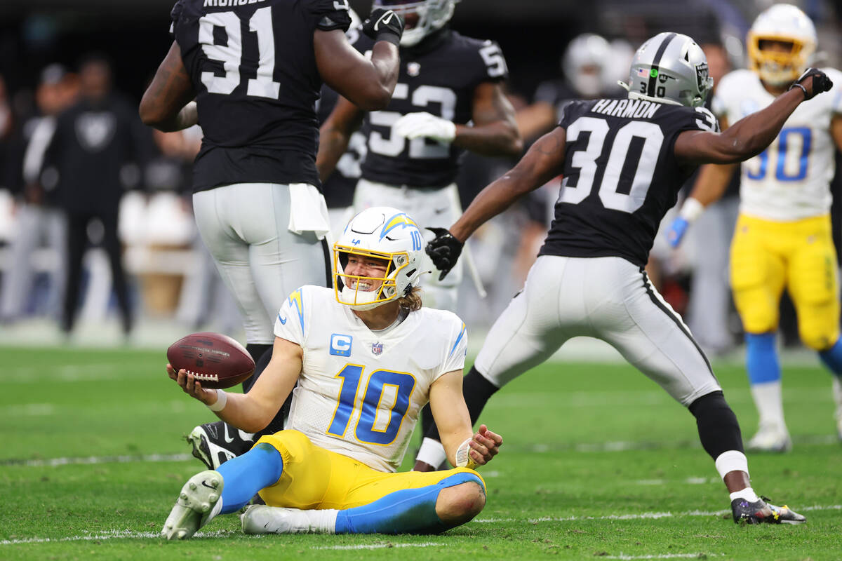 Los Angeles Chargers quarterback Justin Herbert (10) reacts after getting tackled by the Raider ...
