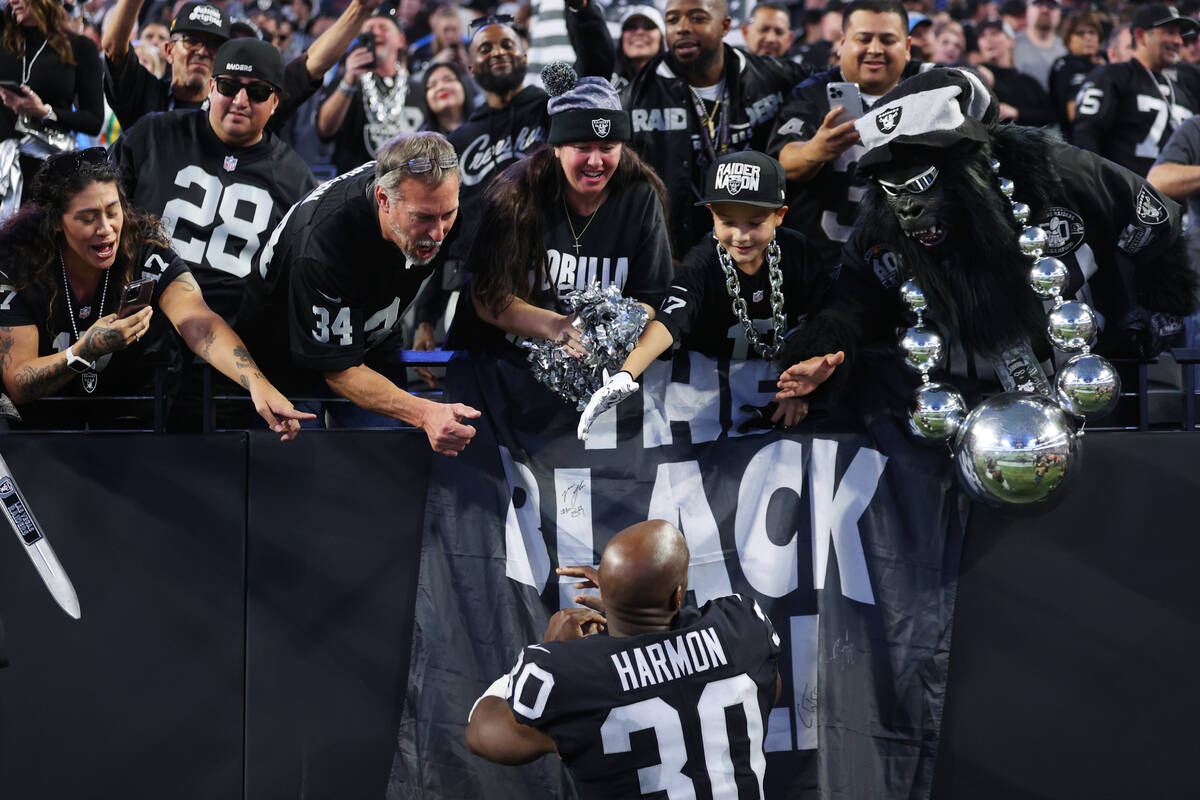 Raiders safety Duron Harmon (30) meets fans follow a NFL football game between the Raiders and ...