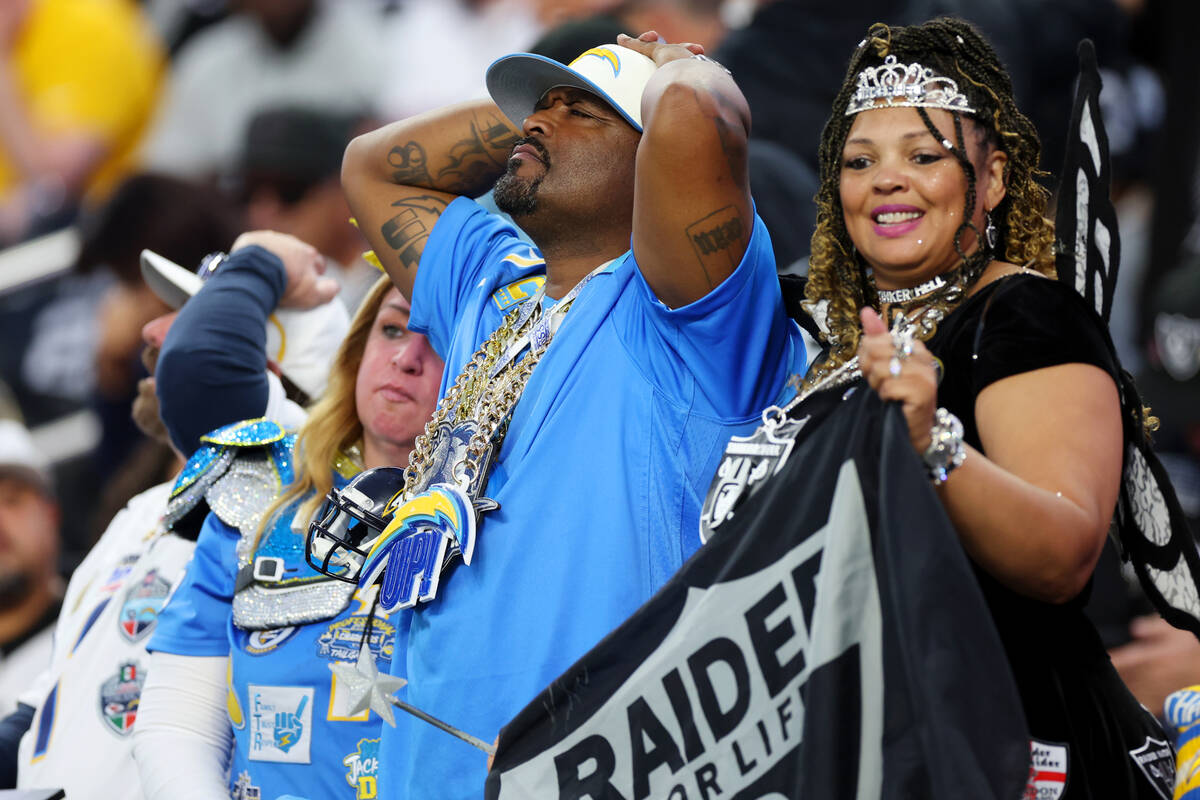 Fans react after a play during the second half of a NFL football game between the Raiders and t ...