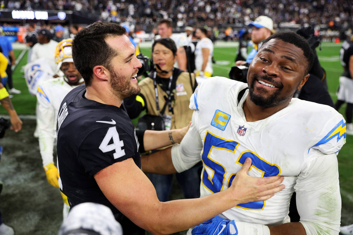 Raiders quarterback Derek Carr (4) shares a moment with Los Angeles Chargers linebacker Khalil ...