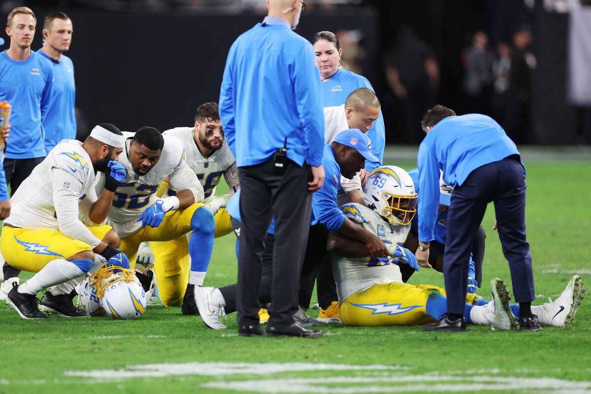 Los Angeles Chargers defensive tackle Sebastian Joseph-Day (69) receives assistance after a pla ...