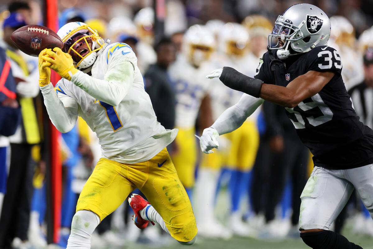 Raiders cornerback Nate Hobbs (39) defends a pass for Los Angeles Chargers wide receiver DeAndr ...
