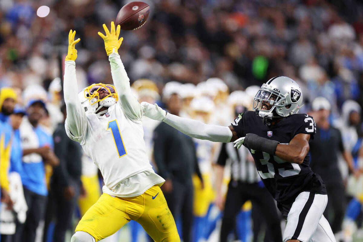 Raiders cornerback Nate Hobbs (39) defends a pass for Los Angeles Chargers wide receiver DeAndr ...