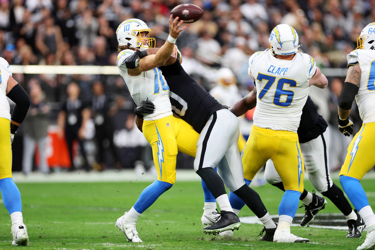 Raiders defensive tackle Jerry Tillery (90) tackles Los Angeles Chargers quarterback Justin Her ...