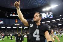 Raiders quarterback Derek Carr (4) walks the field following a 27-20 win against the Los Angel ...