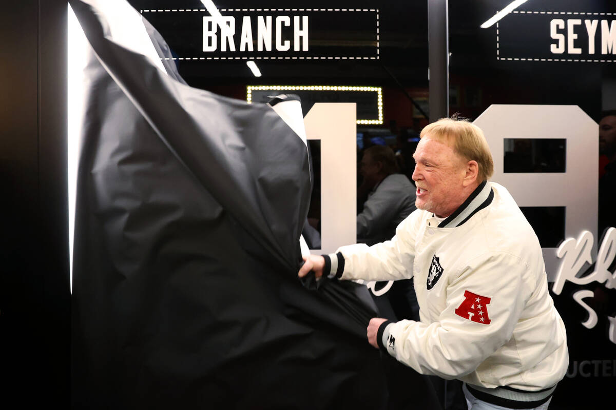 Raiders owner Mark Davis unveils the hall of fame plaque for Cliff Branch during a program cere ...