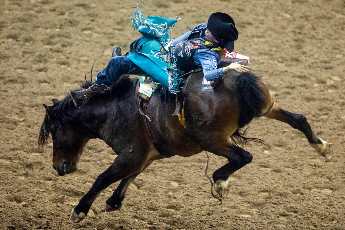 Jess Pope of Waverly, Kan., competes during Bareback Riding in the National Finals Rodeo Day 4 ...