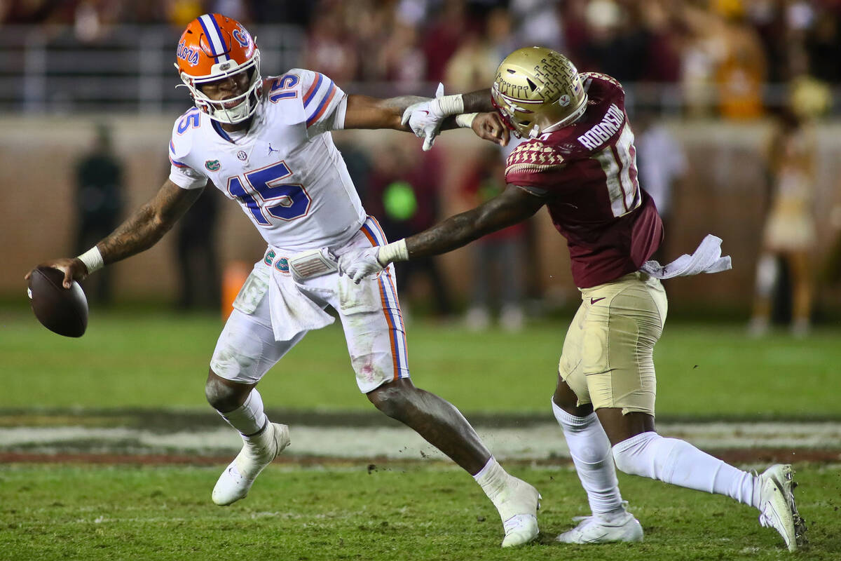 Florida quarterback Anthony Richardson (15) is pressured by Florida State defensive back Jammie ...