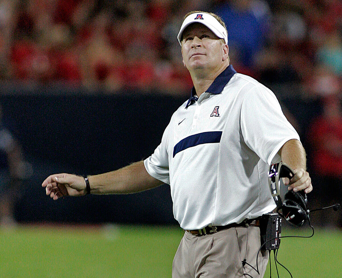 FILE - In this Sept. 3, 2011, file photo, Arizona coach Mike Stoops looks at the stadium video ...
