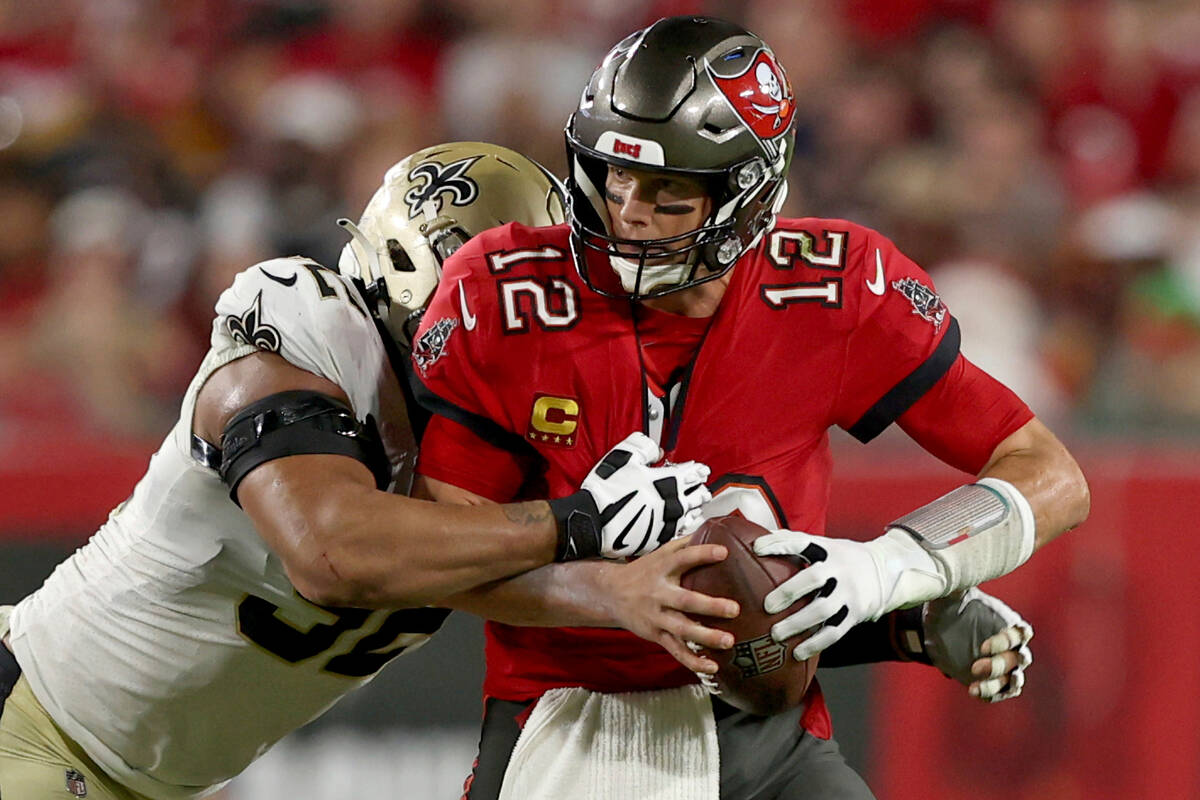 Tampa Bay Buccaneers quarterback Tom Brady (12) is sacked by New Orleans Saints defensive end M ...