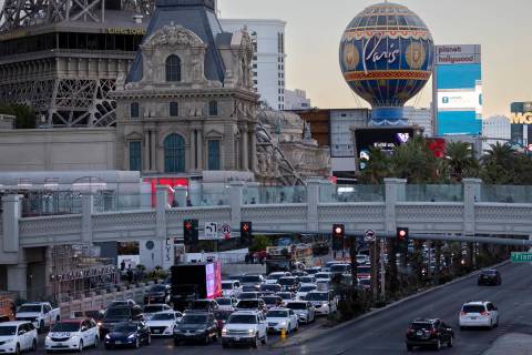 Pedestrians and traffic travel along the Strip on Las Vegas Boulevard, Tuesday, Nov. 29, 2022, ...