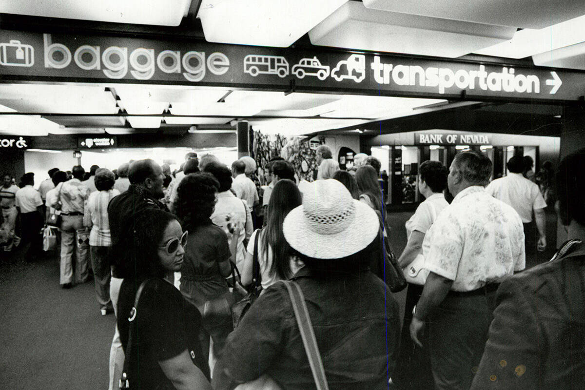 Passengers en route to pick up baggage at McCarran International Airport on Aug. 5, 1977. (Gary ...