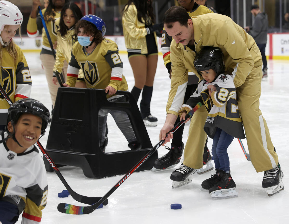 Former UMC Children’s Hospital patient Nanea Castillo, 5, shoots a puck with the help of ...