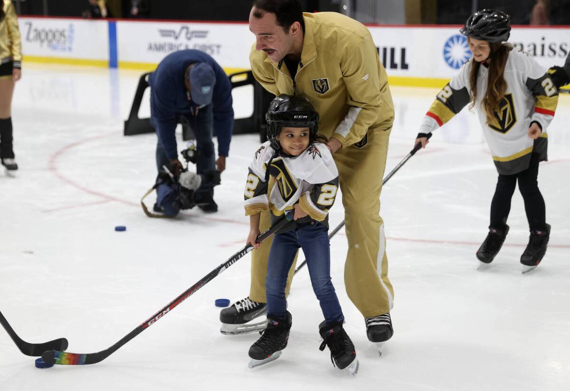 Former UMC Children’s Hospital patient Nanea Castillo, 5, shoots a puck with the help of ...
