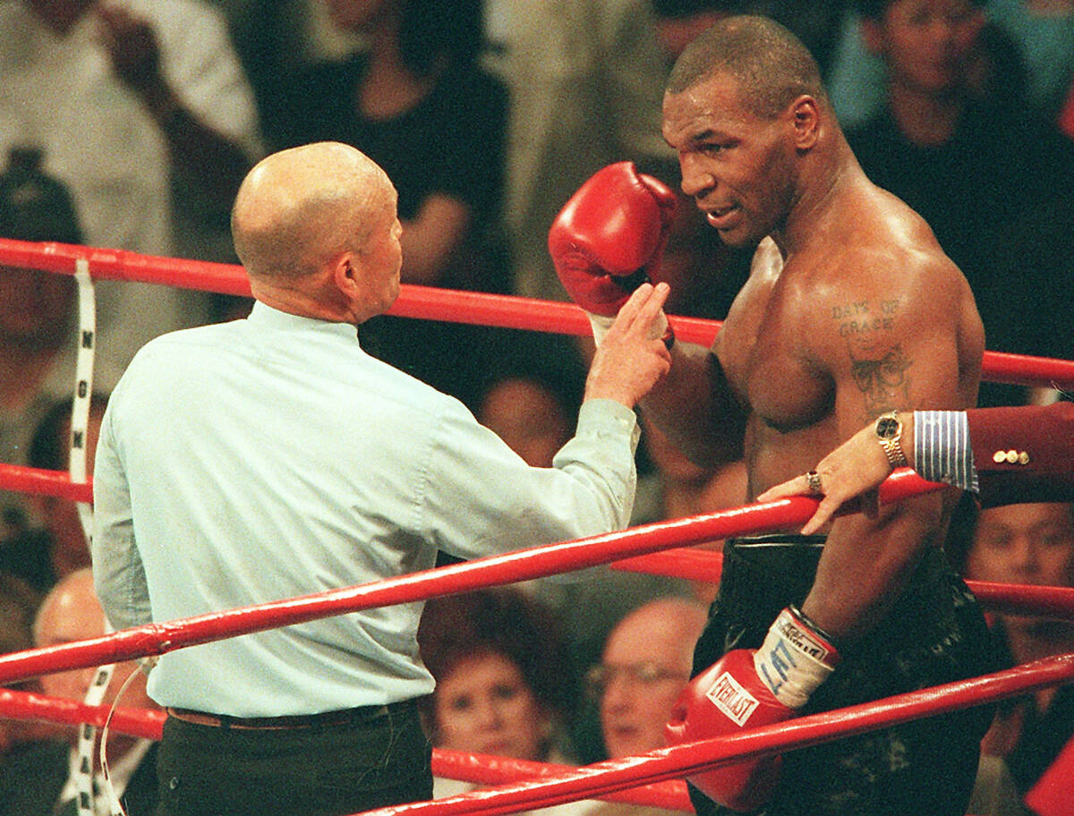 Referee Mills Lane warns boxer Mike Tyson after Tyson bit the ear of opponent Evander Holyfield ...