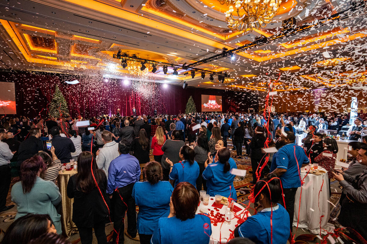 Employees at The Venetian celebrate as confetti fills the air after Patrick Nichols, president ...