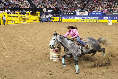 Lisa Lockhart, of Oelrichs, S.D., competes in barrel racing during the fifth go-round of the Na ...