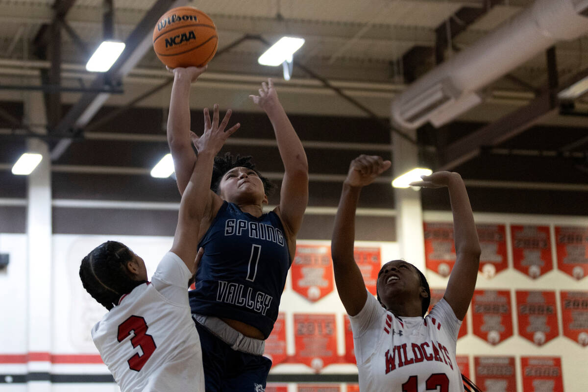 Spring Valley’s Mia Ervin (1) shoots against Las Vegas’ Vernonie Newson (3) and J ...