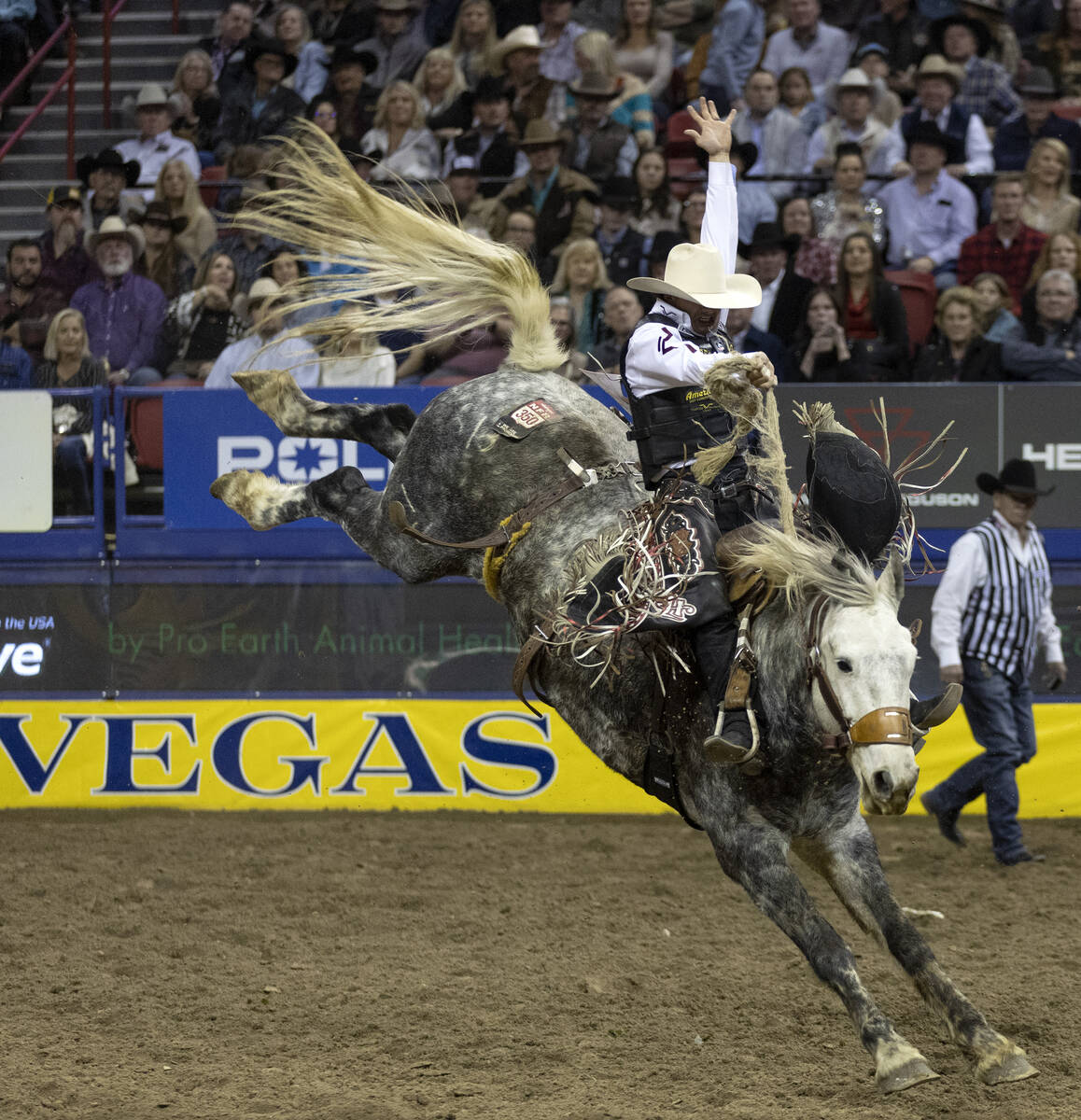 Lefty Holman, of Visalia, Calif., competes in saddle bronc riding during the sixth go-round of ...