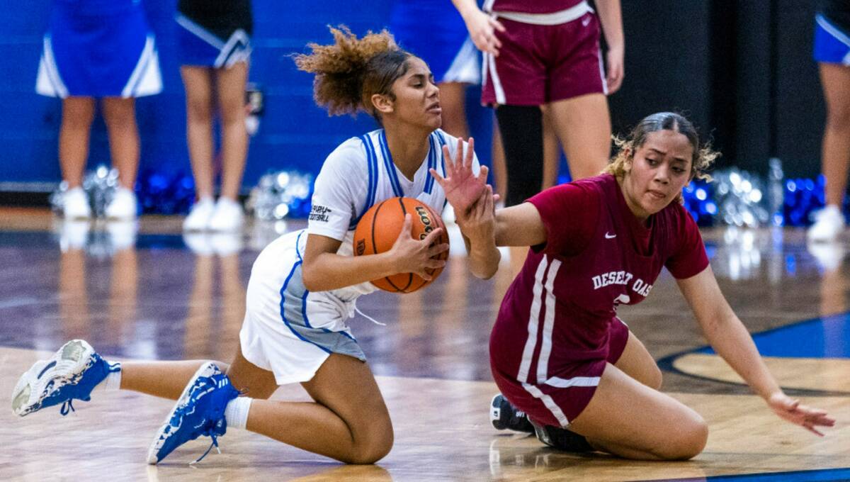 Desert Pines guard Tatianna Wilder (3) secures loose ball as Desert Oasis guard Savanna Sadler ...