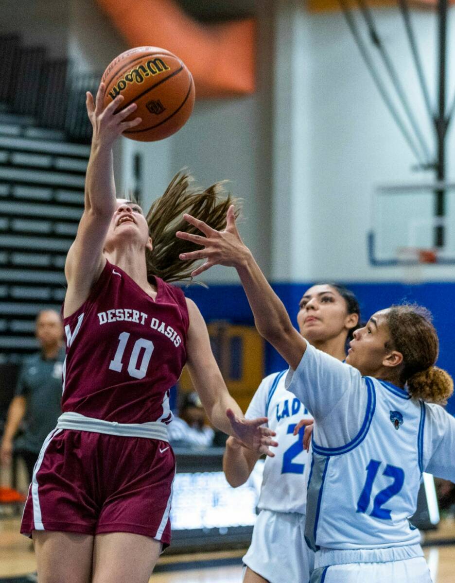 Desert Oasis guard Hailey Mannella (10) drives underneath the basket for a shot with Desert Pin ...