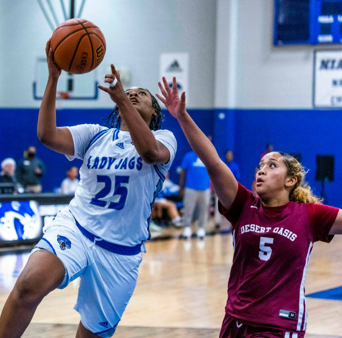 Desert Pines forward Ashanti Stewart (25) beats Desert Oasis guard Savanna Sadler (5) to the ba ...