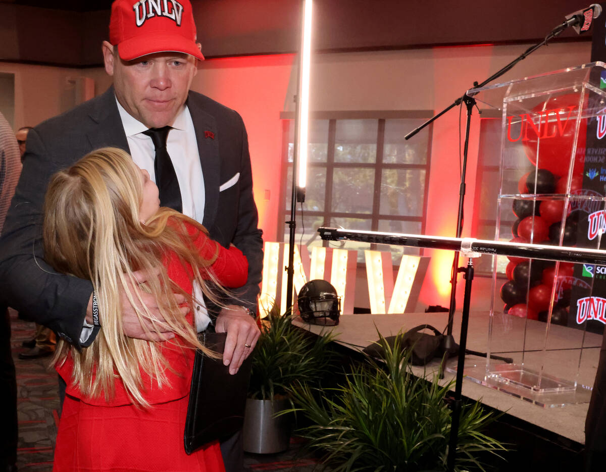 New UNLV football coach Barry Odom gets a hug from his daughter Anna, 7, after being introduced ...