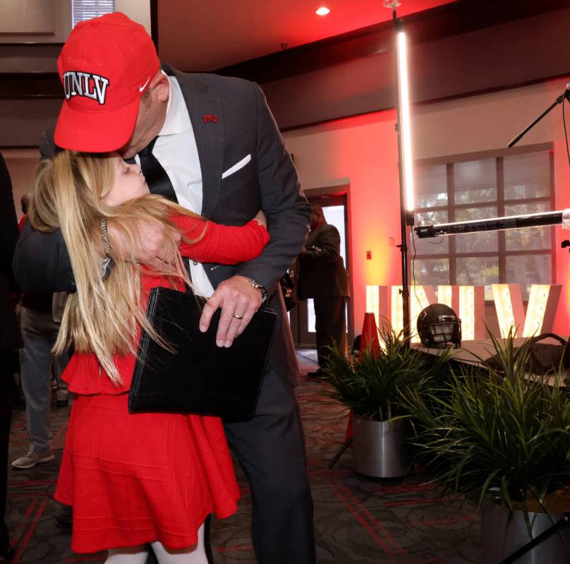 New UNLV football coach Barry Odom gets a hug from his daughter Anna, 7, after being introduced ...