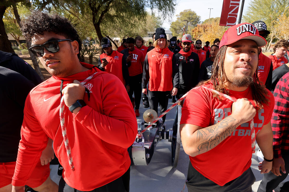 UNLV Football players, including offensive lineman Leif Fautanu, left, and defensive lineman Na ...