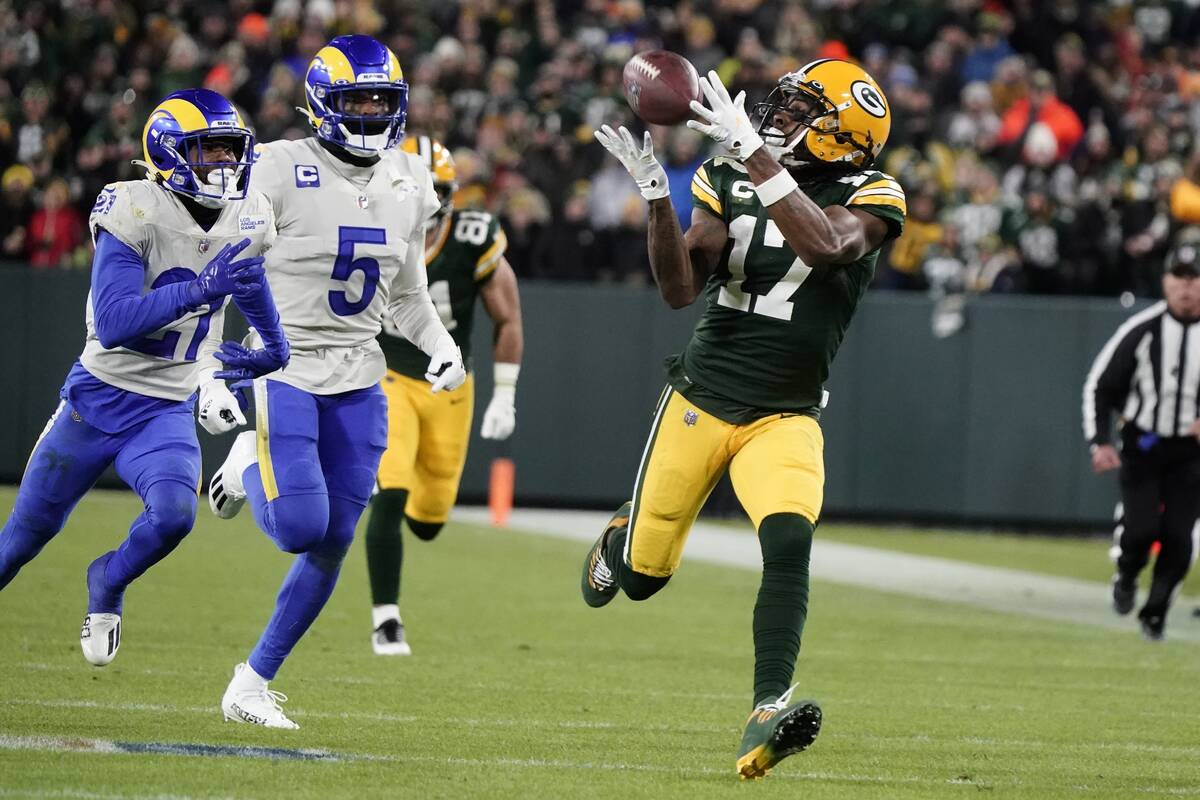 Green Bay Packers' Davante Adams catches a long pass in front of Los Angeles Rams' Jalen Ramsey ...