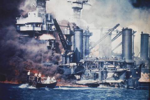FILE - A small boat rescues a USS West Virginia crew member from the water after the Japanese b ...