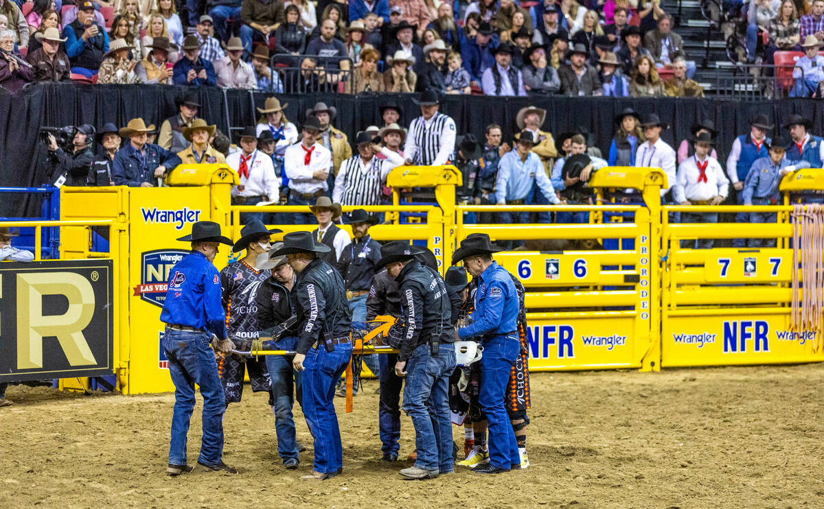 Reid Oftedahl of Raymond, Minn., is carried out of the arena as the crowd looks on after fallin ...