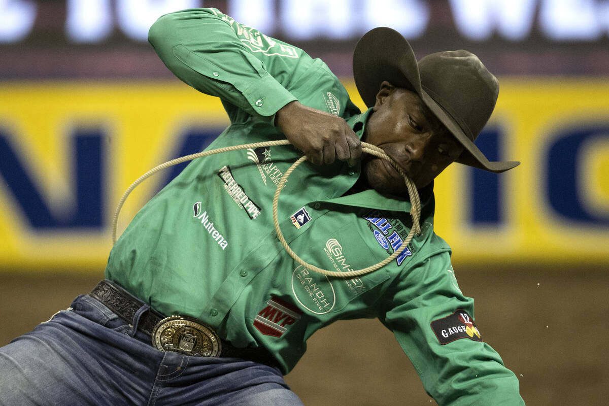 Cory Solomon, of Prairie View, Tex., competes in tie-down roping during the eighth go-round of ...