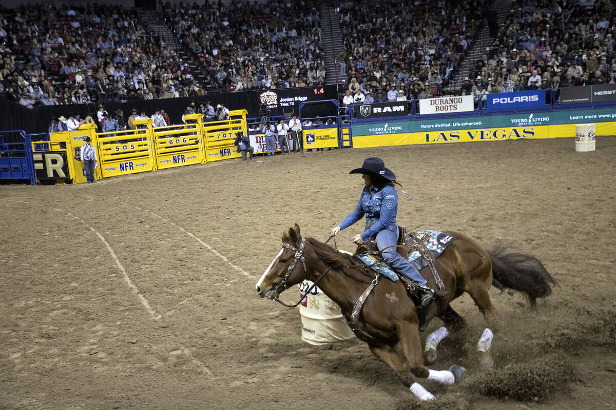Leslie Smalygo, of Skiatook, Okla., rounds the first obstacle in barrel racing during the eight ...