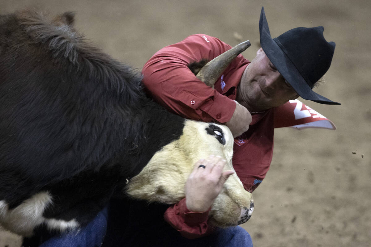 Tristan Martin, of Sulphur La., competes in steer wrestling during the eighth go-round of the N ...