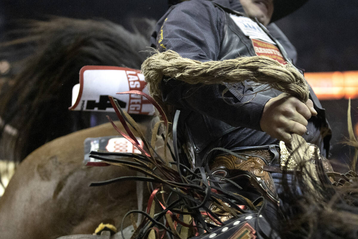 Wyatt Casper, of Miami, Tex., competes in saddle bronc racing during the eighth go-round of the ...