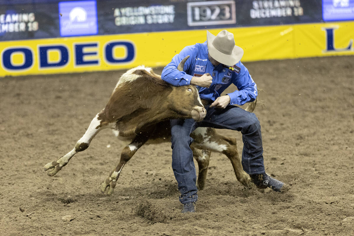 Tyler Waguespack, of Gonzales, La., competes in steer wrestling during the eighth go-round of t ...