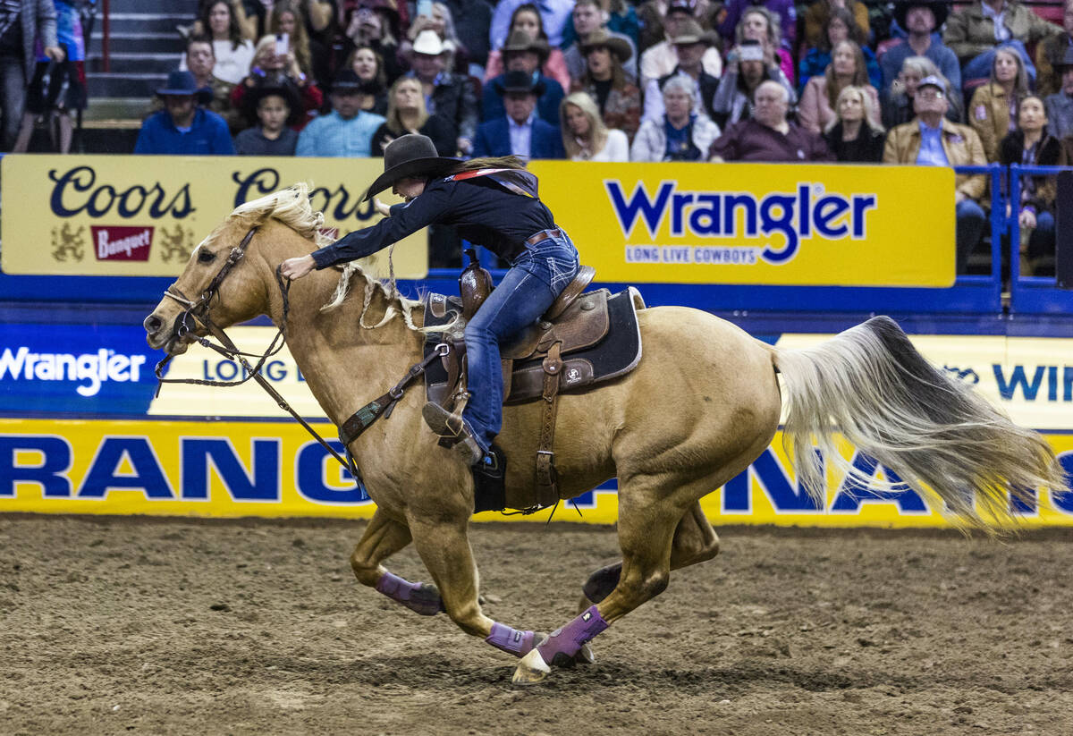 Hailey Kinsel of Cotulla, Texas, races home on the way to her winning time in Barrel Racing dur ...